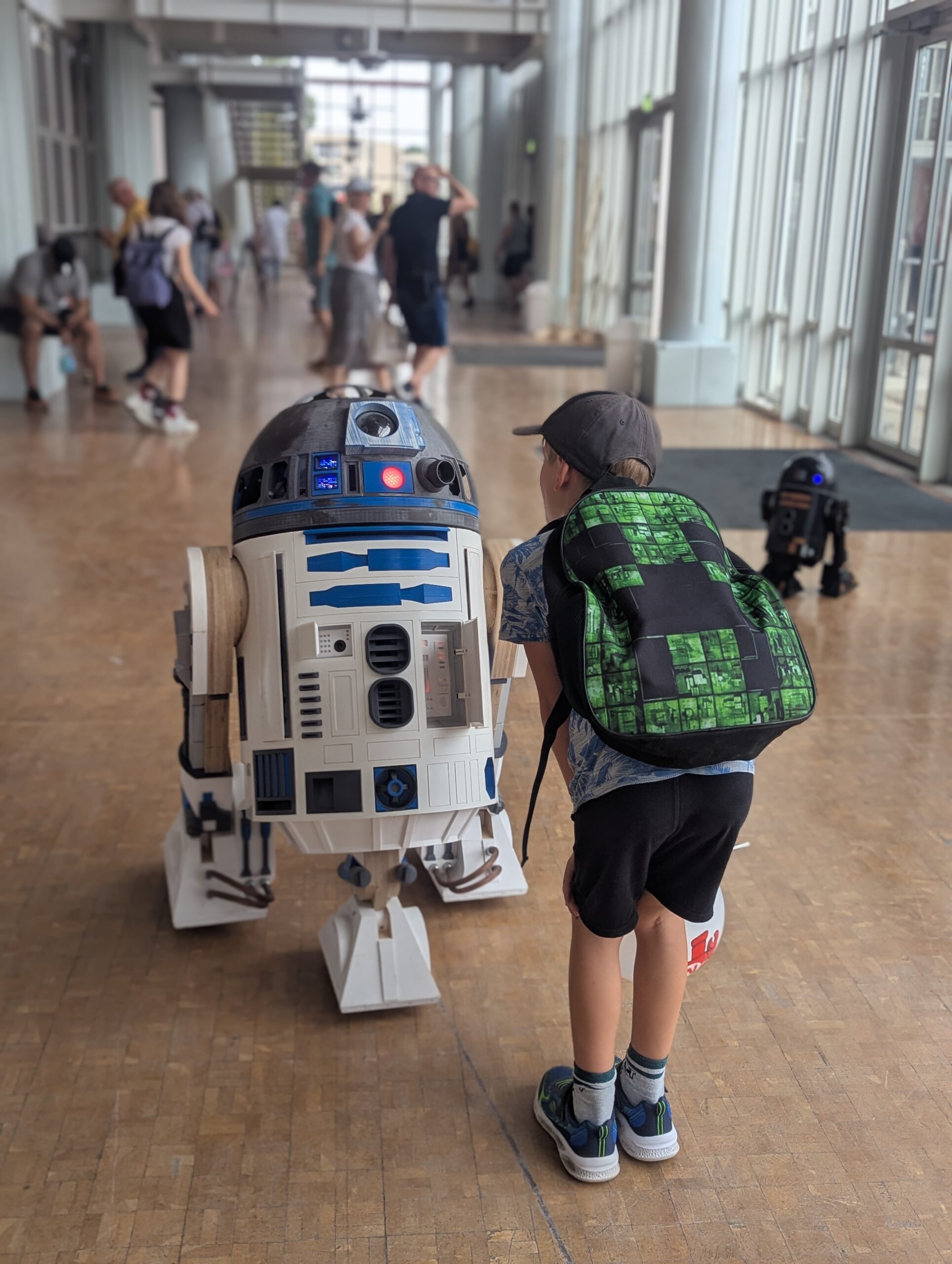 Kind staunt vor einem lebensgroßen R2-D2 Droiden